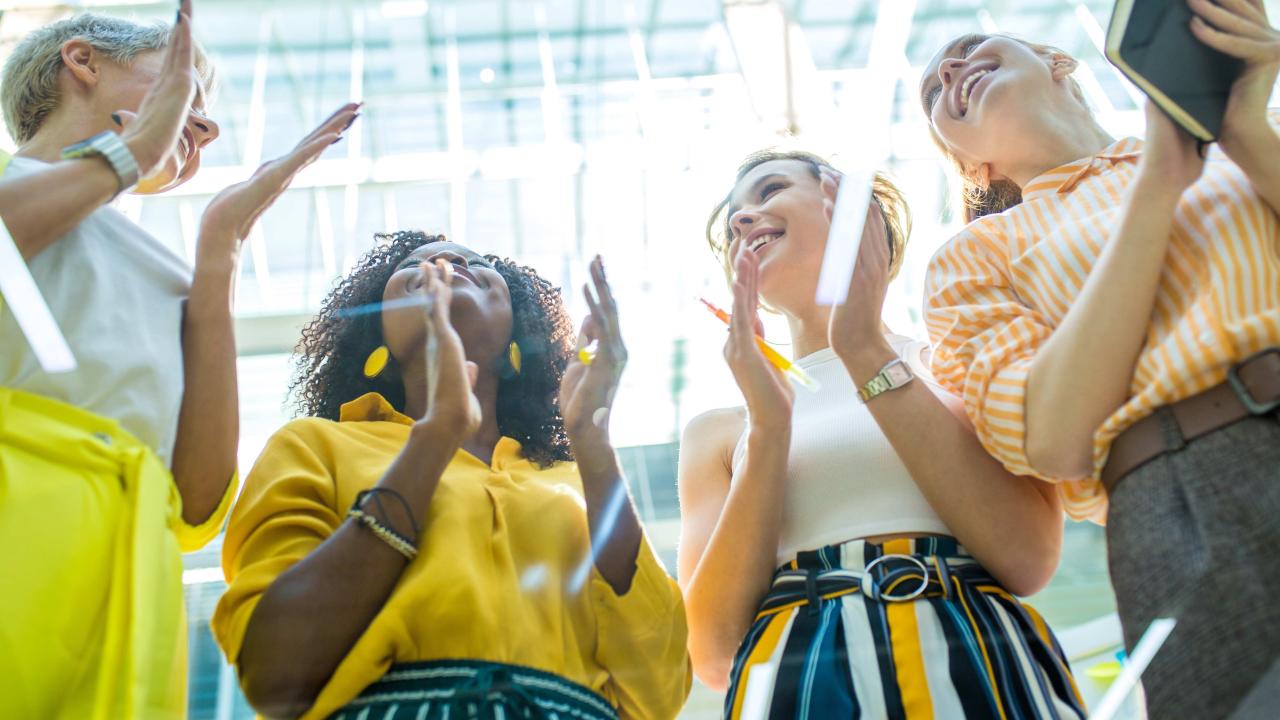 women clapping at conference